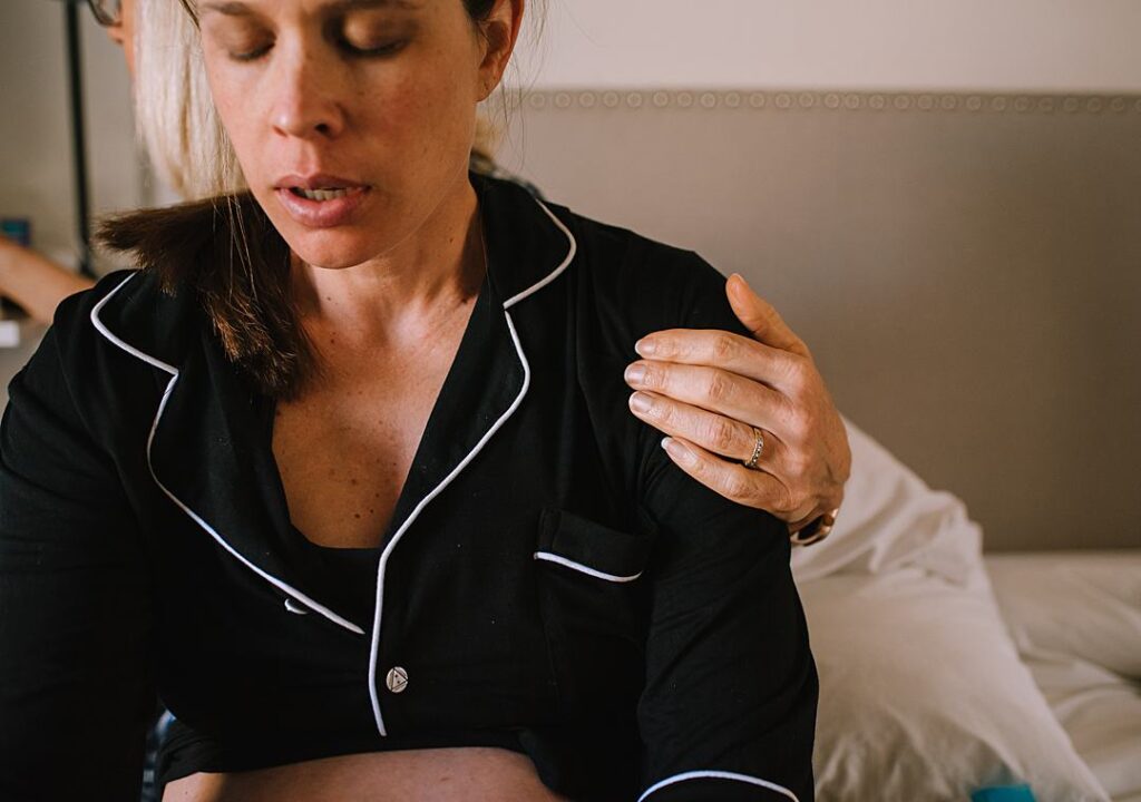 Mother's hand on her daughter who is in labor